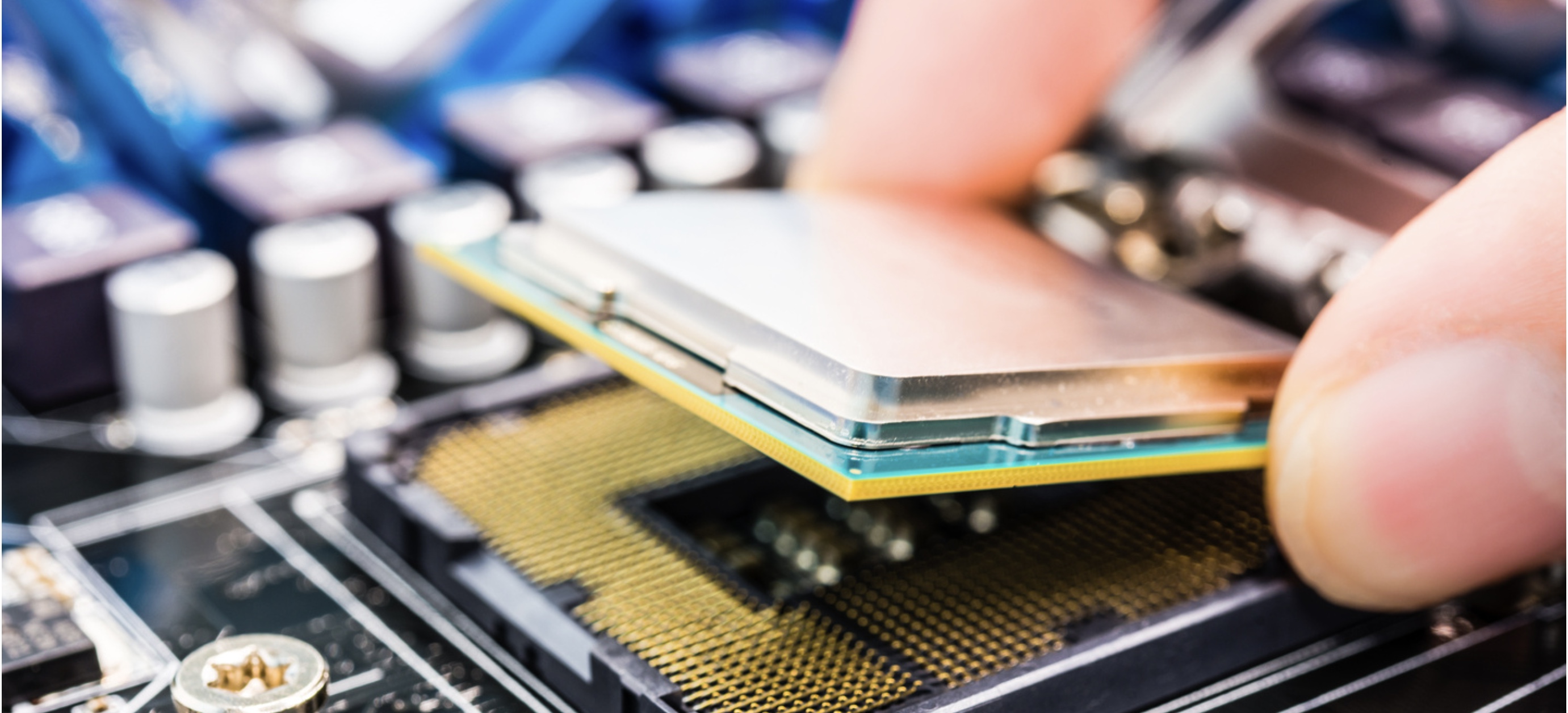 Hand placing a piece in a computer's Central Processing Unit